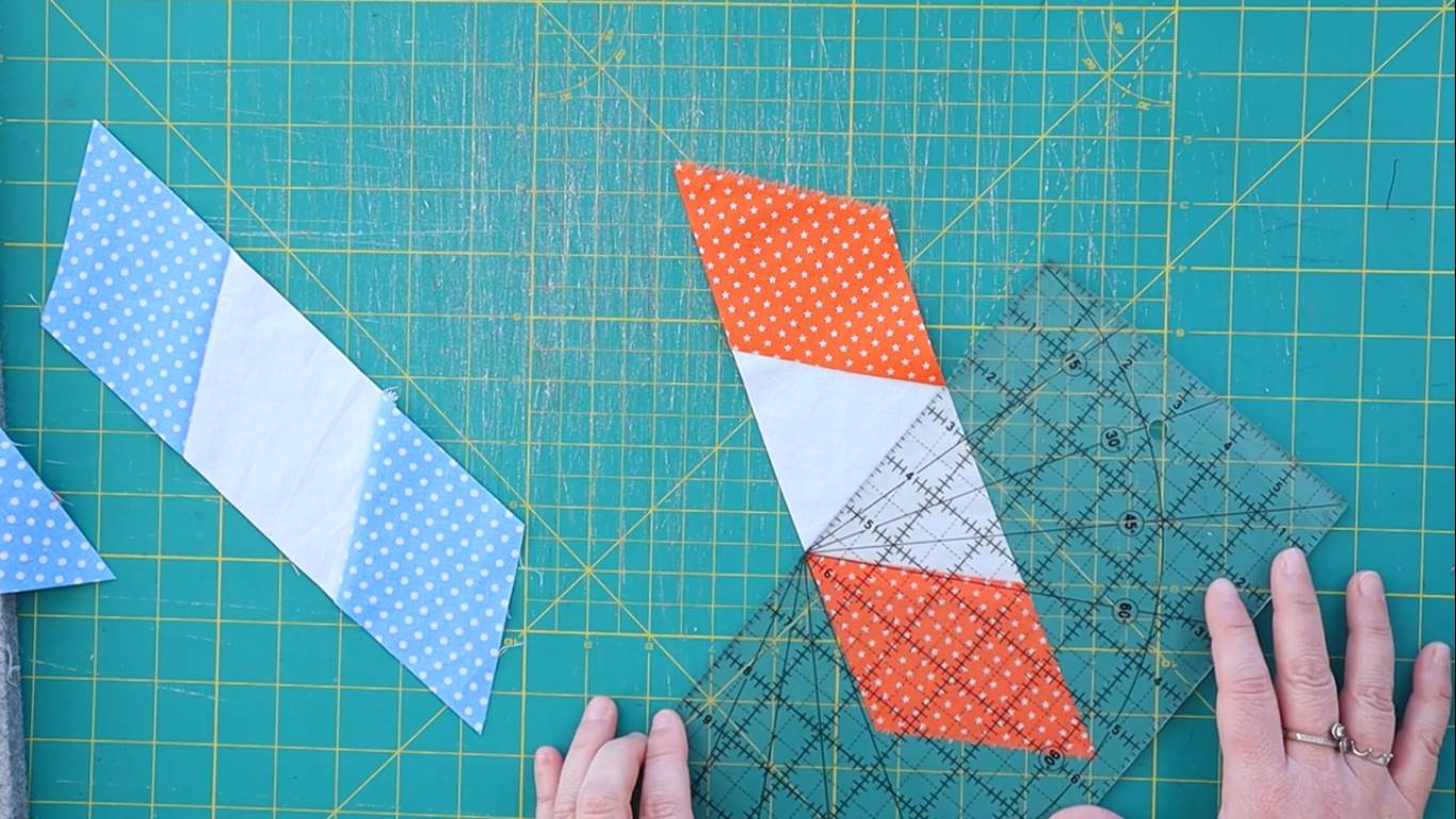 how to make a tumbling quilt block step 5 cutting the strips in half